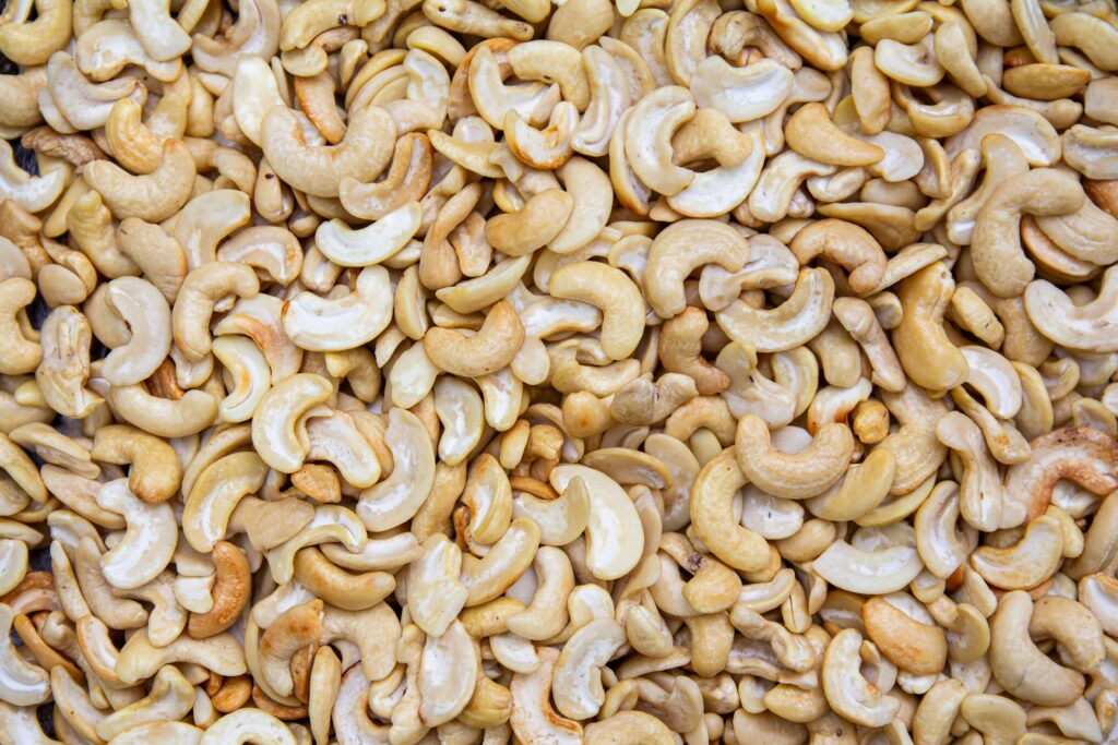 A detailed close-up of roasted cashew nuts creating a textured, appetizing backdrop.
